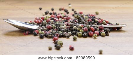 pepper sprinkled on raw wood.