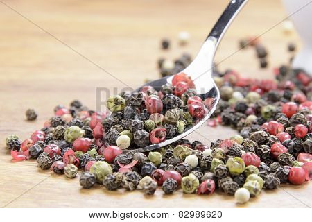pepper sprinkled on raw wood.