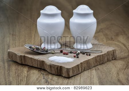 Salt and pepper sprinkled on raw wood.Salt and pepper sprinkled on raw wood.