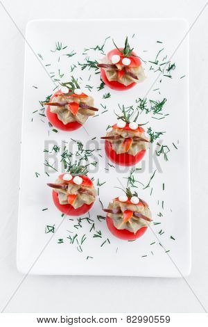 Many small tomatoes stuffed with eggplant baba ganoush