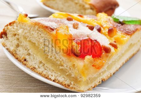closeup of a piece of coca de Sant Joan, a typical sweet flat cake from Catalonia, Spain eaten on Saint Johns Eve, on a plate