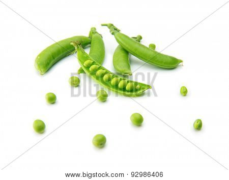 Fresh green peas isolated on a white. Focus on center. 