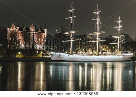 Red Castle And A Boat At Night In Stockholm, Sweden
