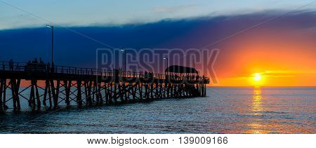 People relaxing on the Henley Beach Jetty at sunset South Australia