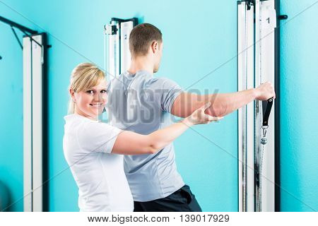 Patient at the physiotherapy doing physical exercises with Bowden cable 