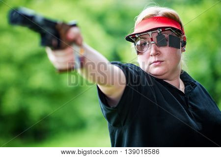 Sport shooting woman, selective focus, horizontal image