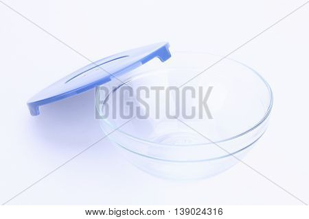 glass food container with blue plastic lid isolated on white background.
