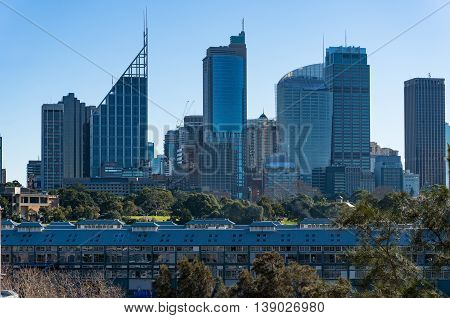 Fingers wharf with Sydney Central Business District skyline skyscrapers on sunny day