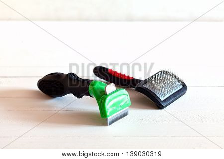 Furminators Grooming cats and dogs. Tools for the care of the animals on a white background