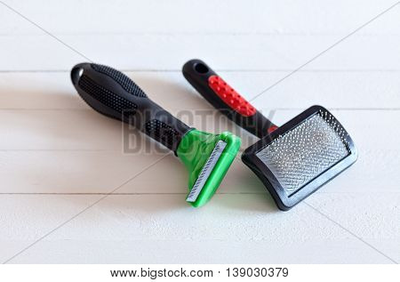 Furminators Grooming cats and dogs. Tools for the care of the animals on a white background
