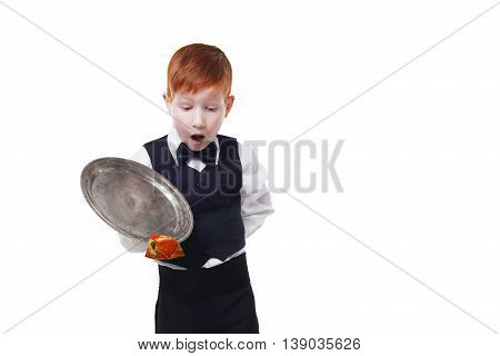 Clumsy little waiter drops tray serving piece of pizza, food falling down. Redhead child boy in suit shows inattentive waiter failure at white background