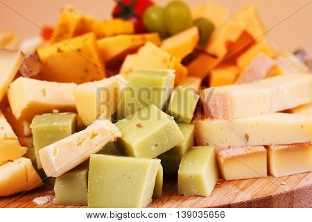 Cut french cheese blocks background close up