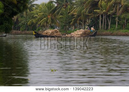 Allepey, Kerala, India - March 31, 2015: Some men transport, overload, put on them head bag of rice