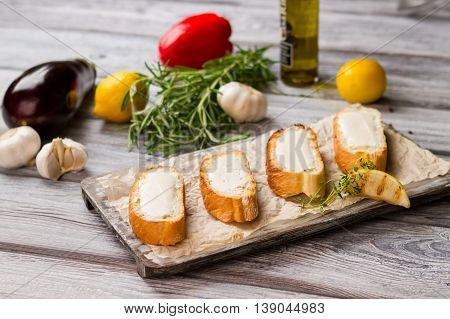 Slices of bread with butter. Grilled lemon and green herb. Healthy food for dinner. Basic ingredient for sandwiches.
