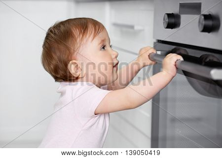 Child playing with electric oven