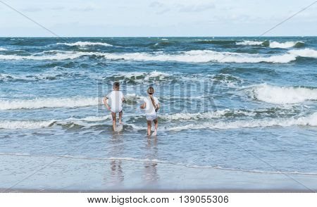 boy and girl on the sea waves