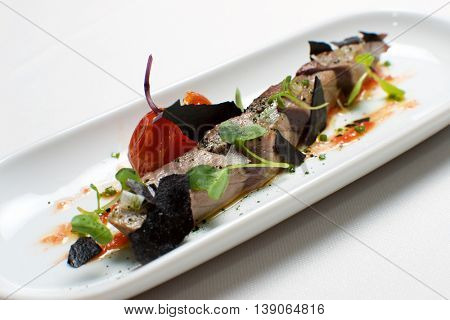 Typical tuna tapa in a small white dish.