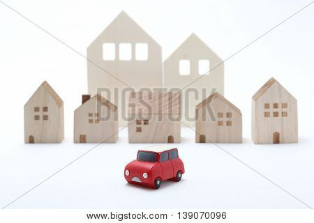 Miniature car and houses on white back ground.
Car sharing concept.