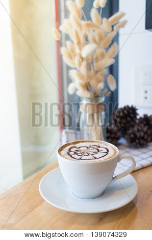 hot coffee with foam milk art. Hot coffee in afternoon break. Coffee cup. coffee mocha on the wood desk. Coffee break.(selective focus vintage effect)