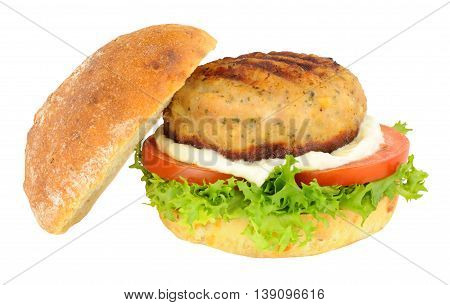 Chicken burger with salad and mayonnaise in a crusty bread roll isolated on a white background