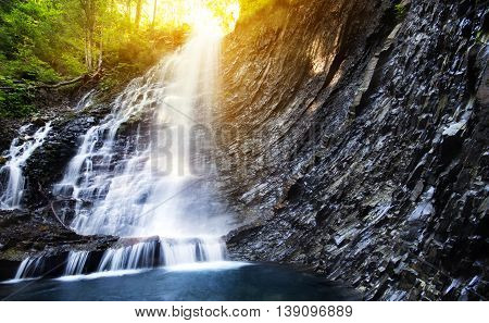 Waterfall in deep moss forest clean and fresh in Carpathians Ukraine.