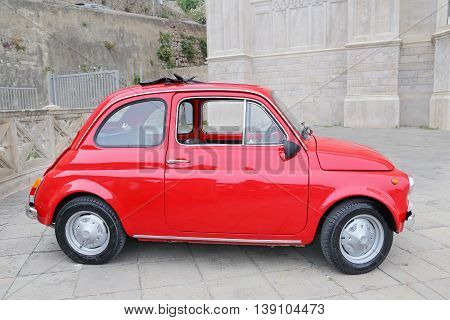 GAETA ITALY - JUNE 25 2016: Fiat 500 on the street in the center of Gaeta. Fiat 500 was produced by the Fiat company from 1957 to 75. New version of the car started production in 2007 Gaeta