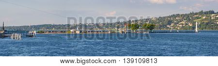 Geneva Switzerland - July 15 2016: Panoramic view of the popular Bains des Paquis an artificial peninsula on lake Geneva it features a public bath a restaurant and a lighthouse at the tip of the jetty.