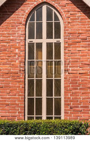tall and narrow chapel window with gothic top shape