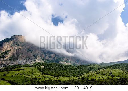 mountains, white clouds in the blue sky, a landscape
