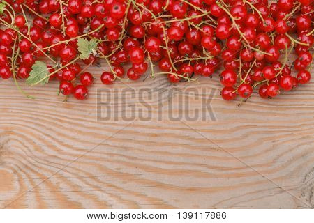 Berries Of A Red Currant And Laptop On The Brown Wooden Texture