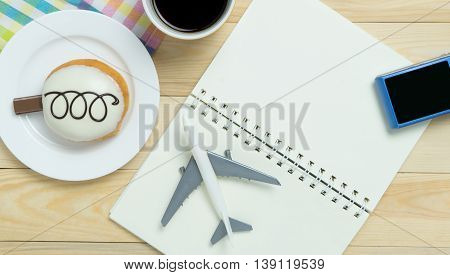 Travel blogger writing book in cafe table pastel tone.
