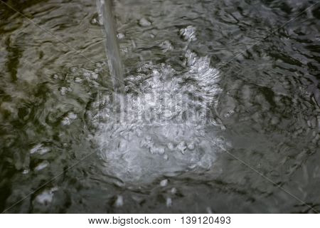 Splashed Water Drops In A Stone Standpipe