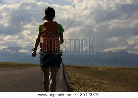 young woman hiker hiking at beautiful mountain trail