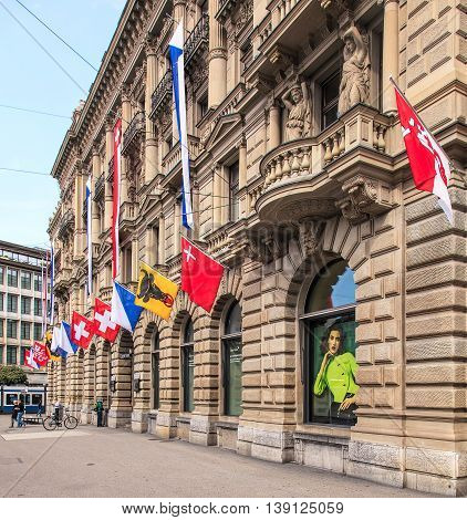 Zurich, Switzerland - 1 August, 2014: facade of the Credit Suisse building on Paradeplatz square decorated with flags. Credit Suisse Group is a Swiss multinational financial services holding company headquartered in Zurich.