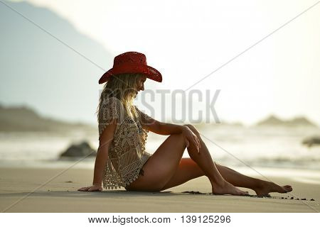 young woman relaxing on the beach in summer day