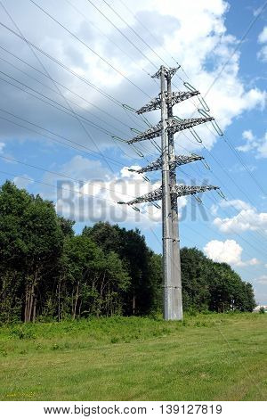 High-voltage power line gray metal props with many wires vertical view closeup