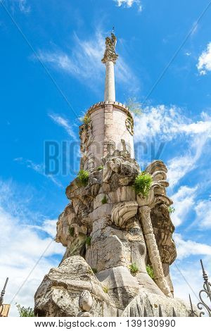 Triunfo de San Rafael, monument in honor of the Archangel, in the blue sky. Cordoba, Andalusia, Spain.