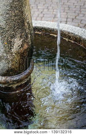 Splashed water drops in a stone standpipe