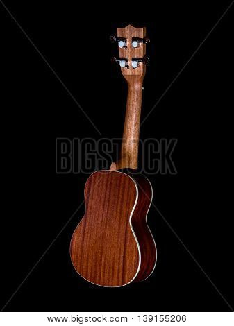 back of hawaii ukulele guitar isolated against black background