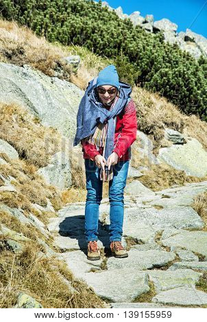 Joyful woman posing on the mountain footpath leading up the peak Dumbier. Hiking theme. Mountains scene. Beauty and fashion. Vertical composition.