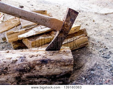 Cut logs firewood and old axe texture background