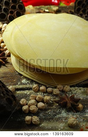 Colorful Indian food - papadum chickpea gram flour and spices on textured wooden table top