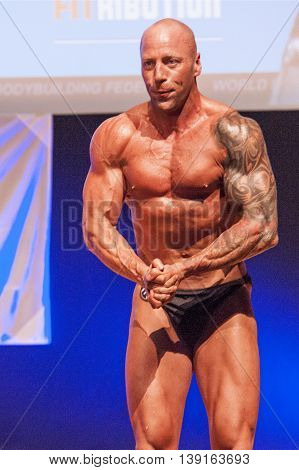MAASTRICHT THE NETHERLANDS - OCTOBER 25 2015: Male bodybuilders flex their muscles and show their best physique on stage at the World Grandprix Bodybuilding and Fitness of the WBBF-WFF on October 25 2015 at the MECC Theatre in Maastricht the Netherlands.