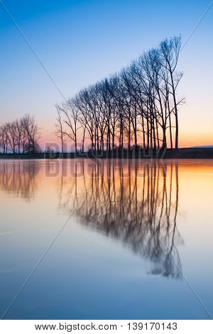 Symmetry - autumn morning on the river before sunrise