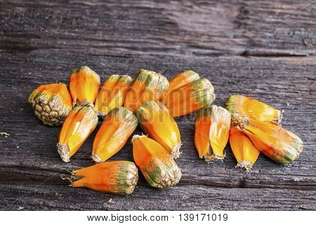 a group of pandan fruit is on the wooden table