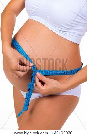 Measuring girth tummy with meter tape. Pregnancy. Pregnant belly