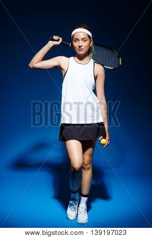 Picture of young fintess girl holding tennis racket