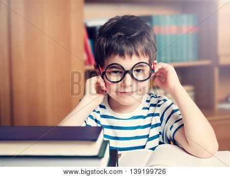 seven years old child reading a book at home