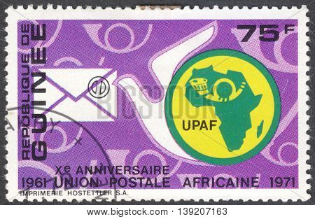 MOSCOW RUSSIA - CIRCA JANUARY 2016: a post stamp printed in GUINEA shows a dove and an envelope the series "The 10th Anniversary of African Postal Union" circa 1972