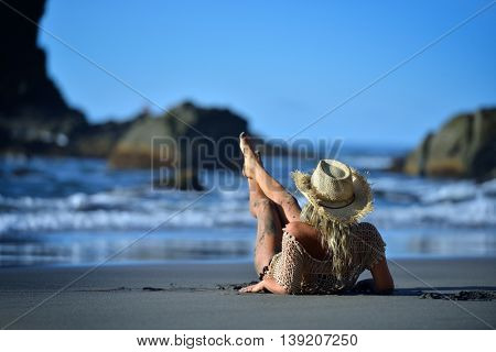 young woman relaxing on the beach in summer day